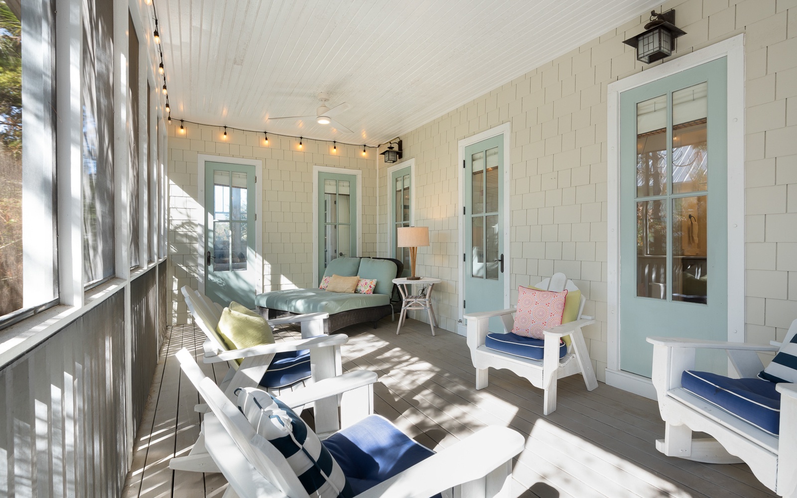 Relax in your private screened porch with cozy seating, string lights, and coastal charm—perfect for morning coffee or evening retreats.