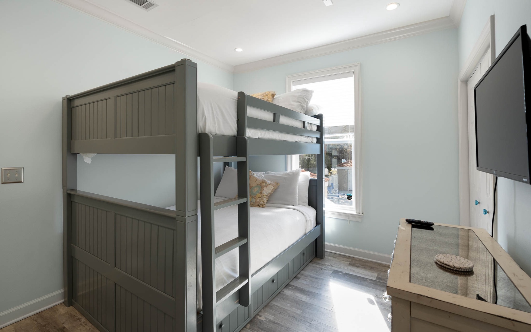 Your kids will love sharing this bright bunk room with crisp linens and built-in entertainment for cozy nights.