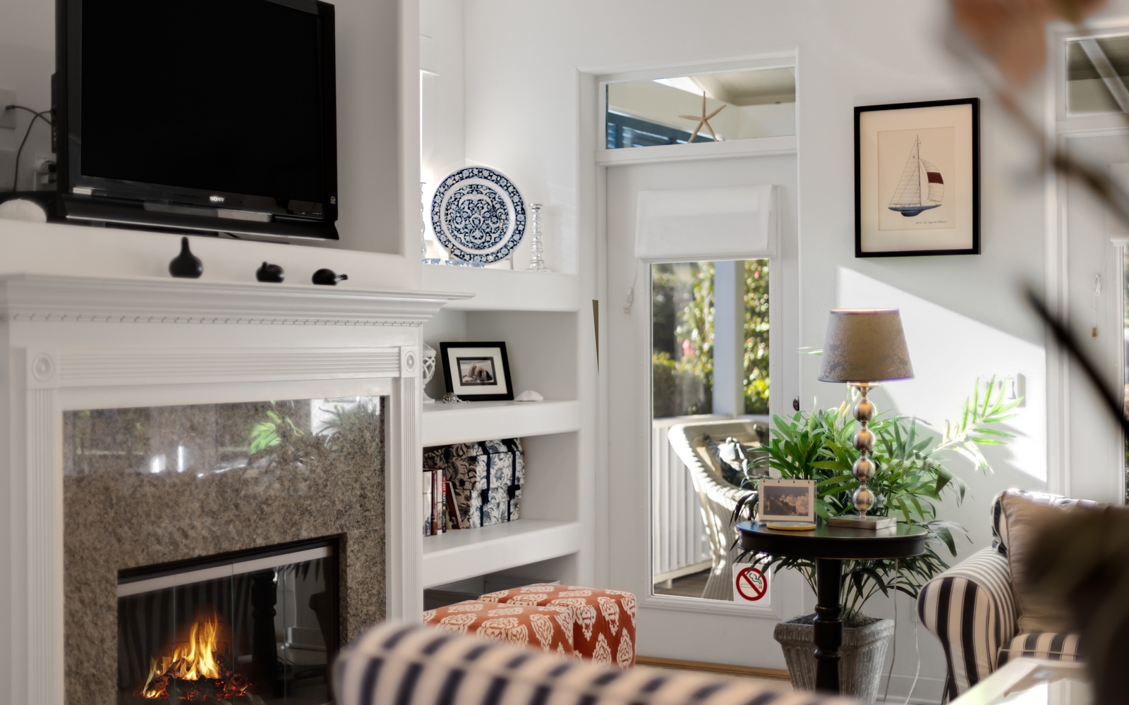 Cozy up by your crackling fireplace while enjoying modern amenities like the flat-screen TV in this elegantly appointed living space.