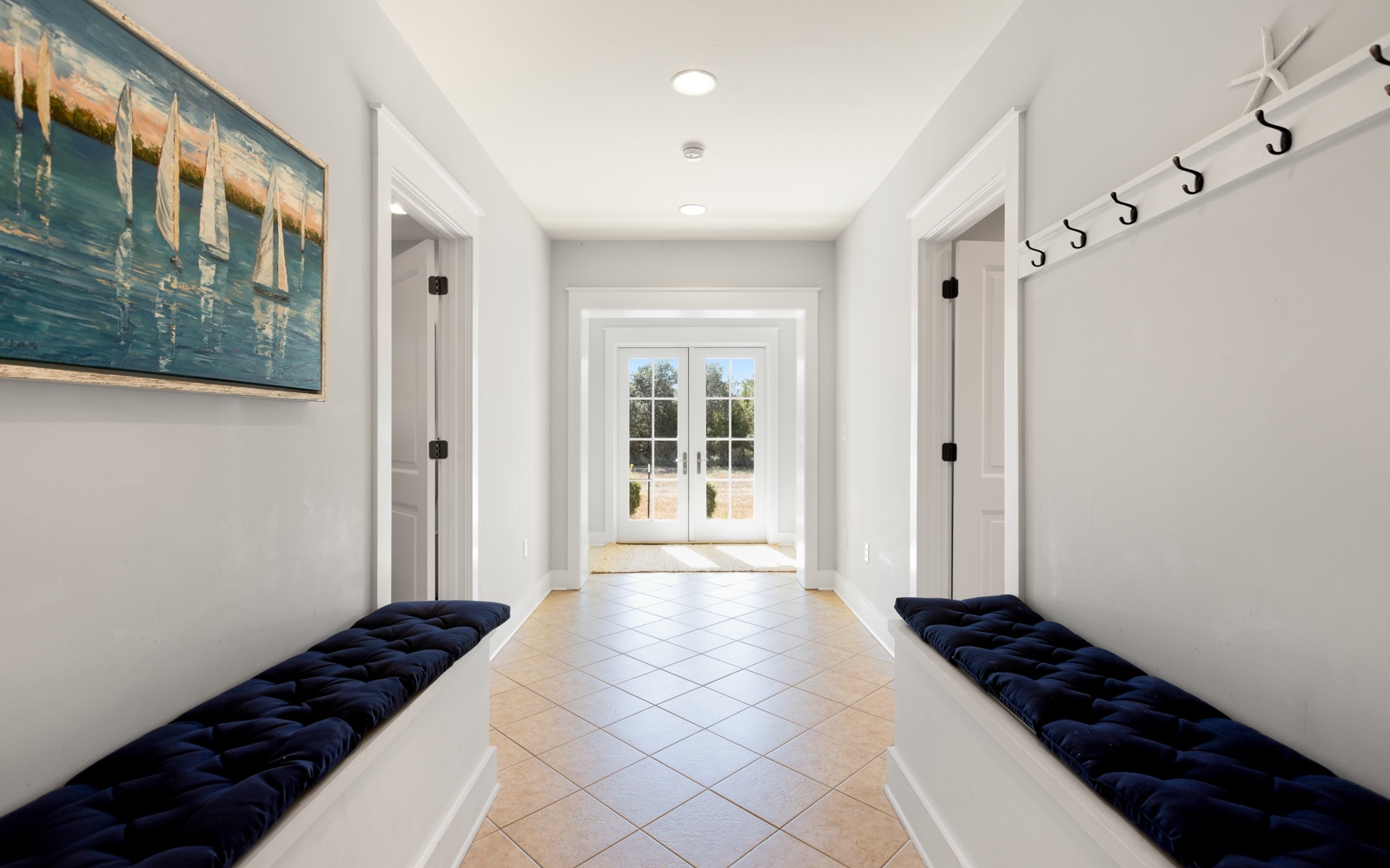 Step into your stylish entryway where nautical charm meets modern comfort—perfect for dropping bags and planning adventures.