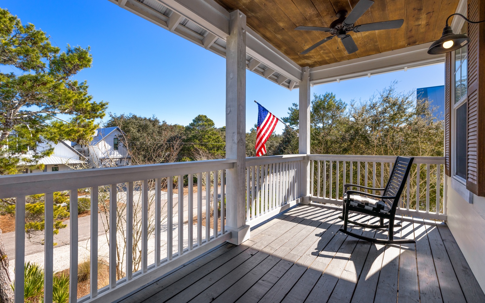 Relax in your private rocking chair on this peaceful covered balcony, where ceiling fans keep you cool while you enjoy tree-lined views.