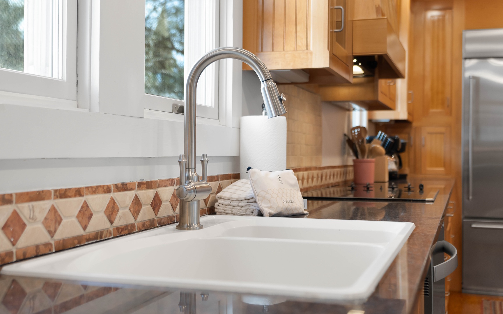 Your fully equipped kitchen features a pull-down faucet, quality appliances, and warm wood cabinetry—perfect for preparing memorable meals.