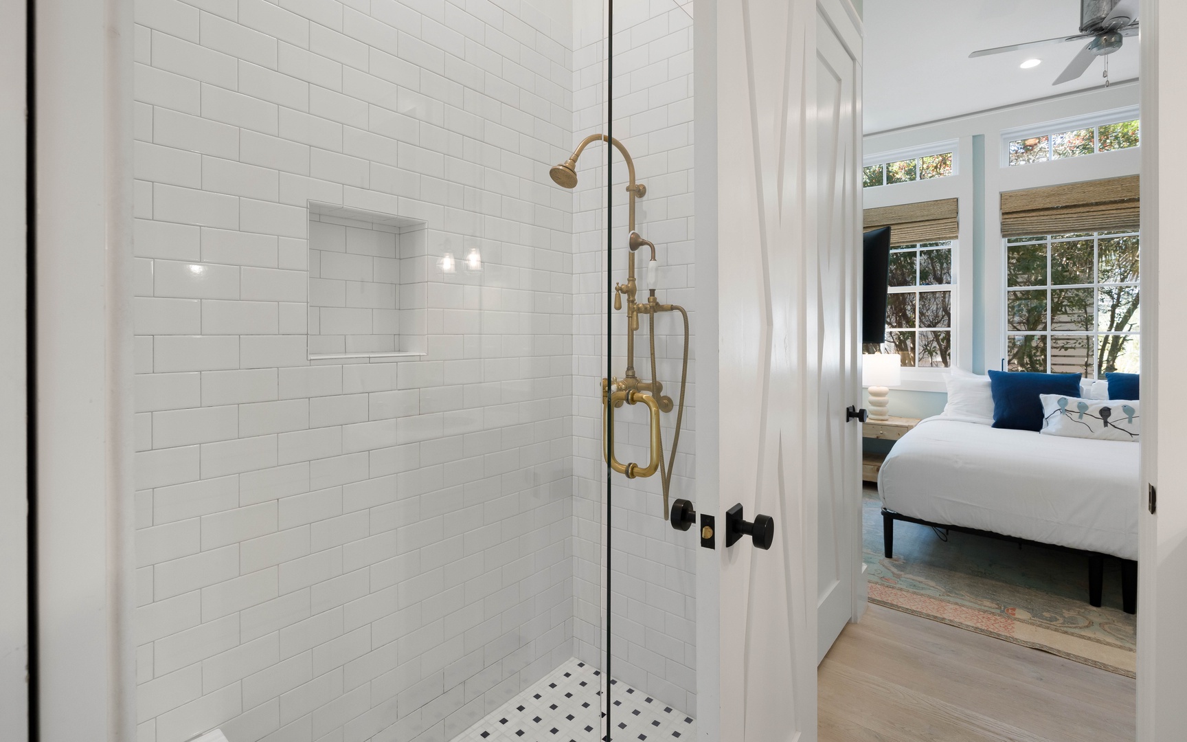 Step into your spa-like shower with gleaming white subway tiles and elegant brass fixtures.