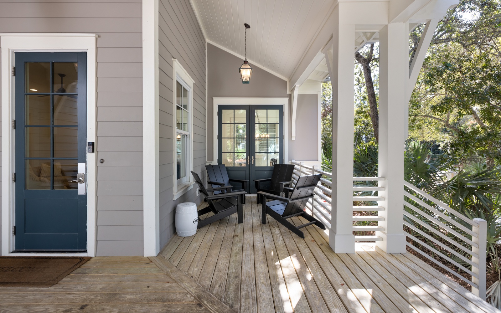 Your private covered porch offers the perfect spot to unwind with morning coffee or evening conversations, surrounded by peaceful garden views.