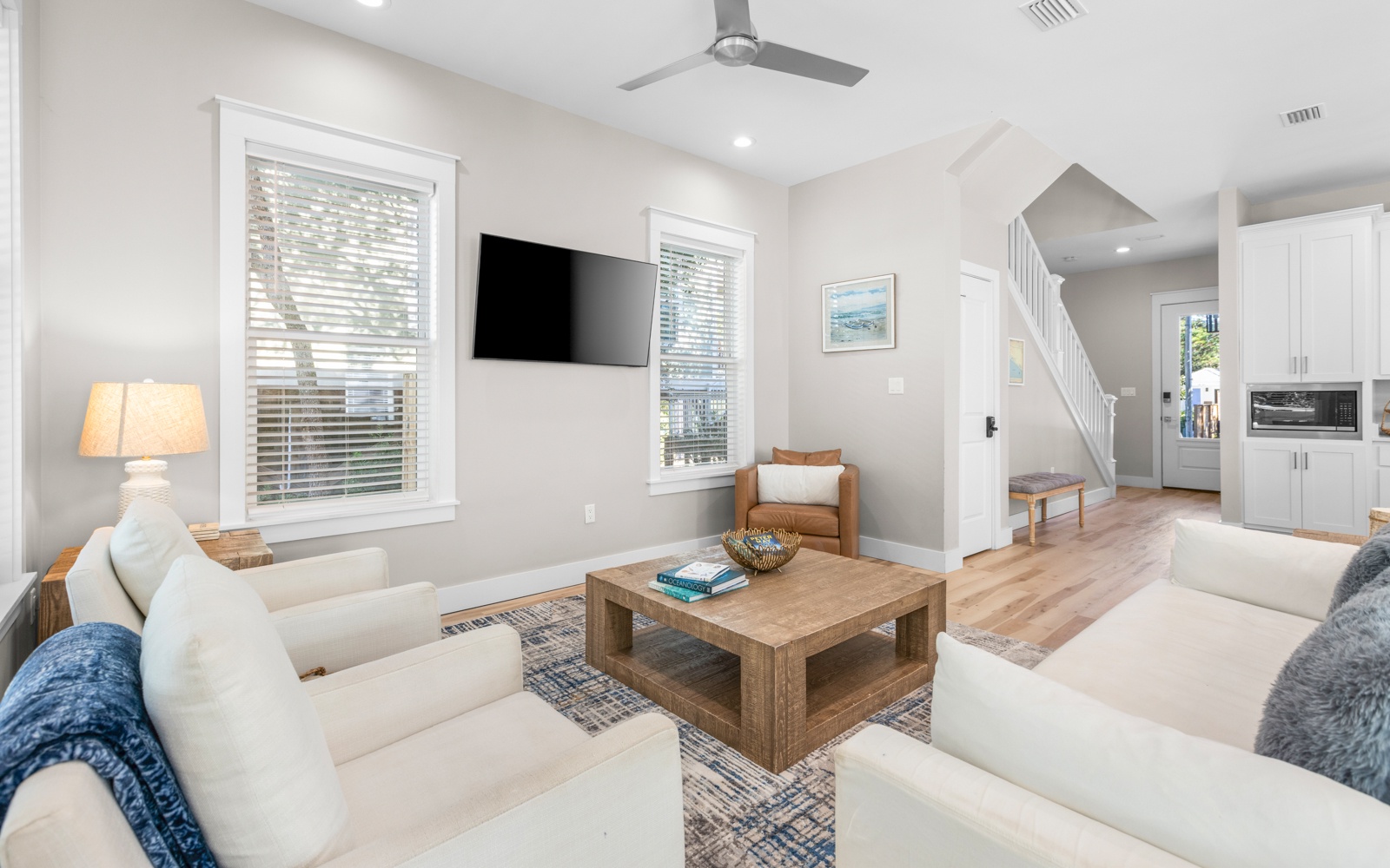 Unwind in your bright, airy living room with plush seating and modern entertainment setup for perfect relaxation.