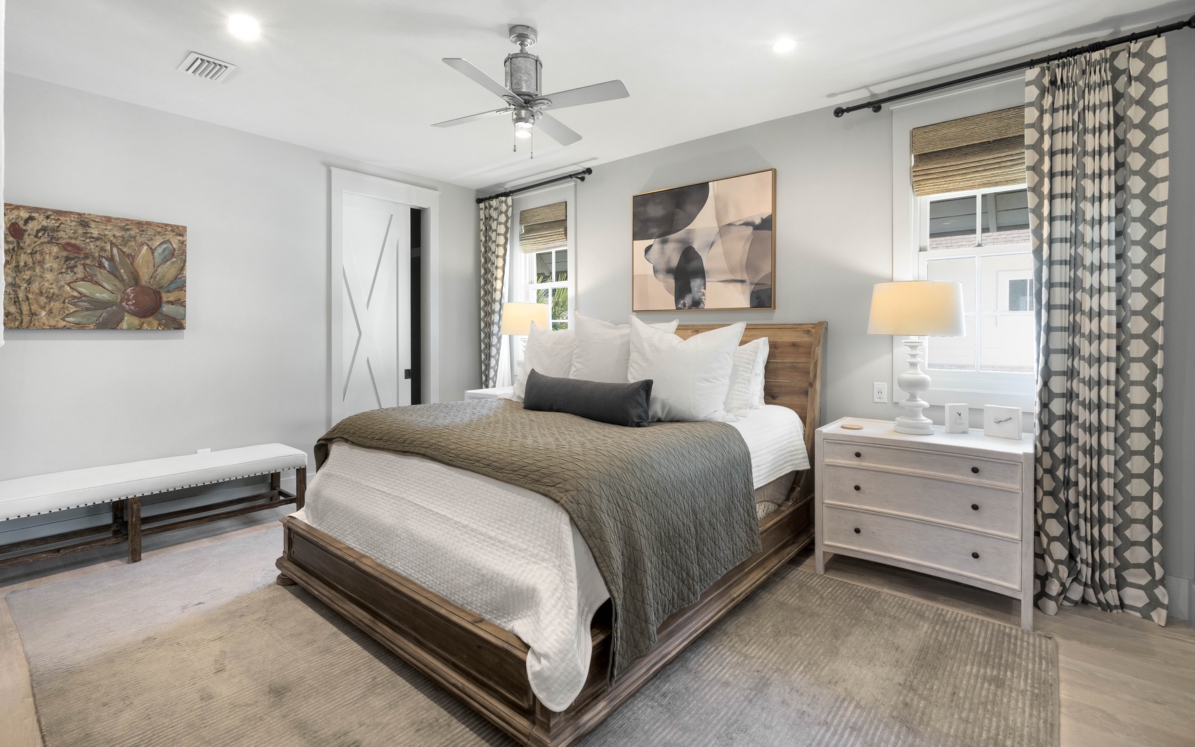 Sink into crisp white linens and cozy textures in your serene bedroom retreat, where warm lighting and thoughtful decor create the perfect haven.
