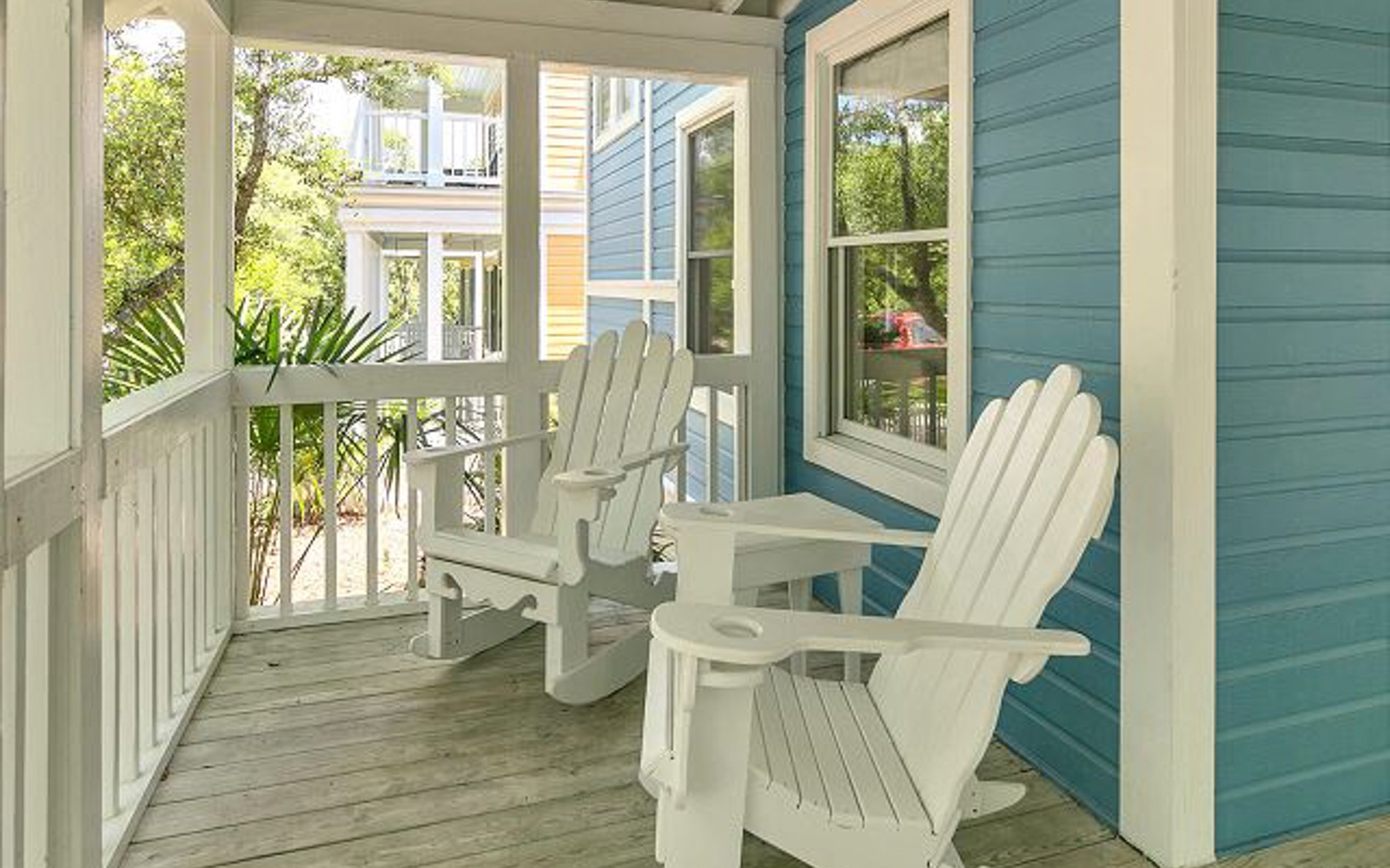 Unwind on your private balcony with classic Adirondack chairs, where morning coffee tastes better surrounded by charming neighborhood views.
