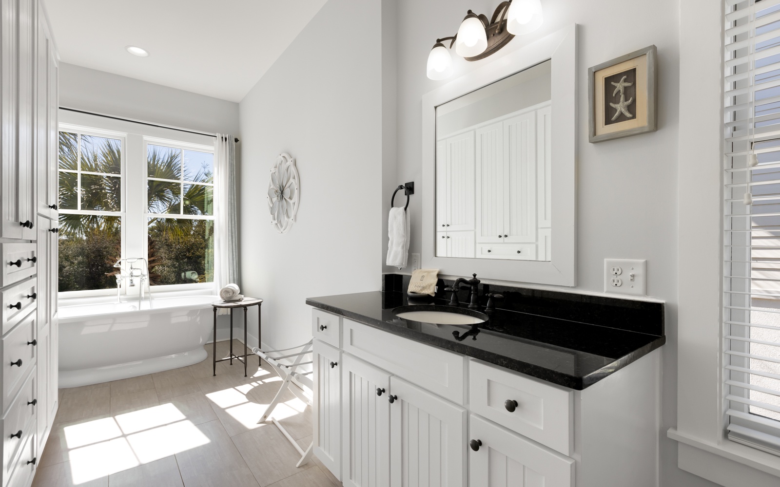 Your elegant bathroom retreat features a luxurious soaking tub where you can unwind while enjoying natural light streaming through windows.
