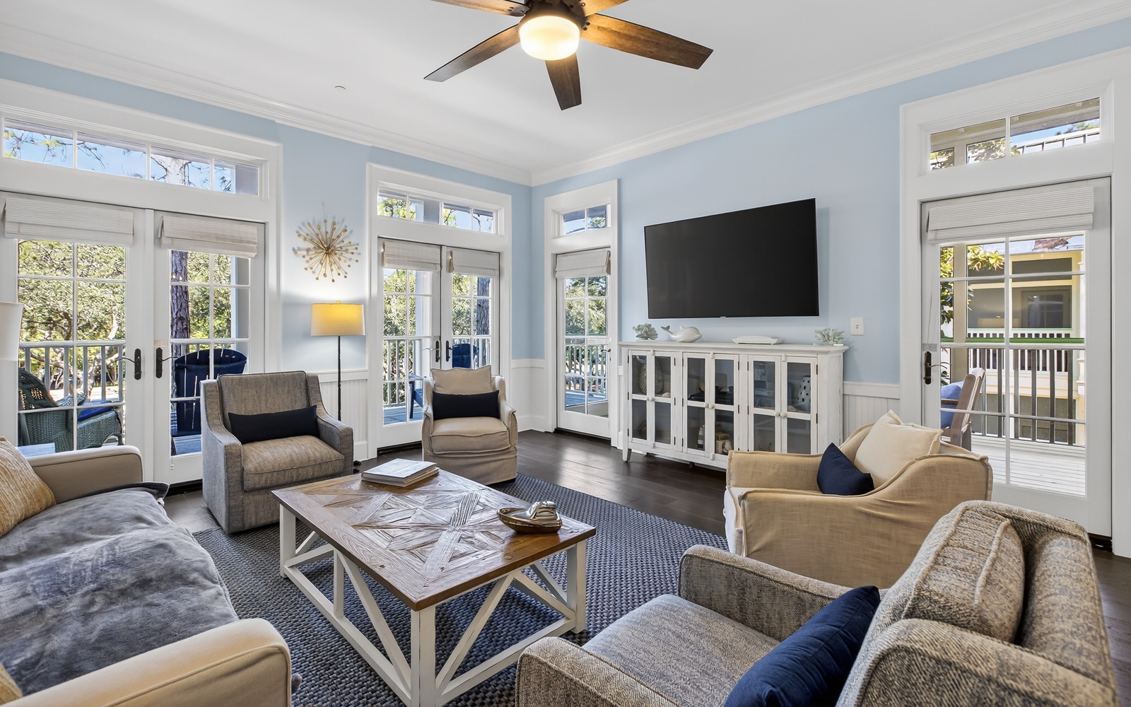 Unwind in your bright, airy living room with French doors opening to private balconies and comfortable seating for memorable moments.