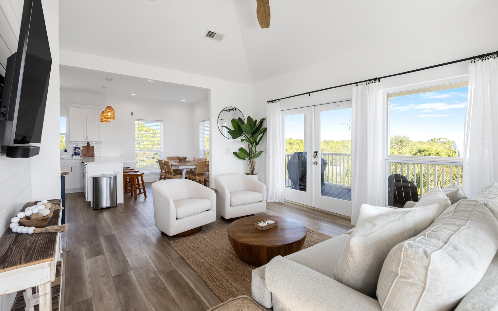 Sink into plush seating in your bright, airy living room where natural light flows through French doors to your private balcony.