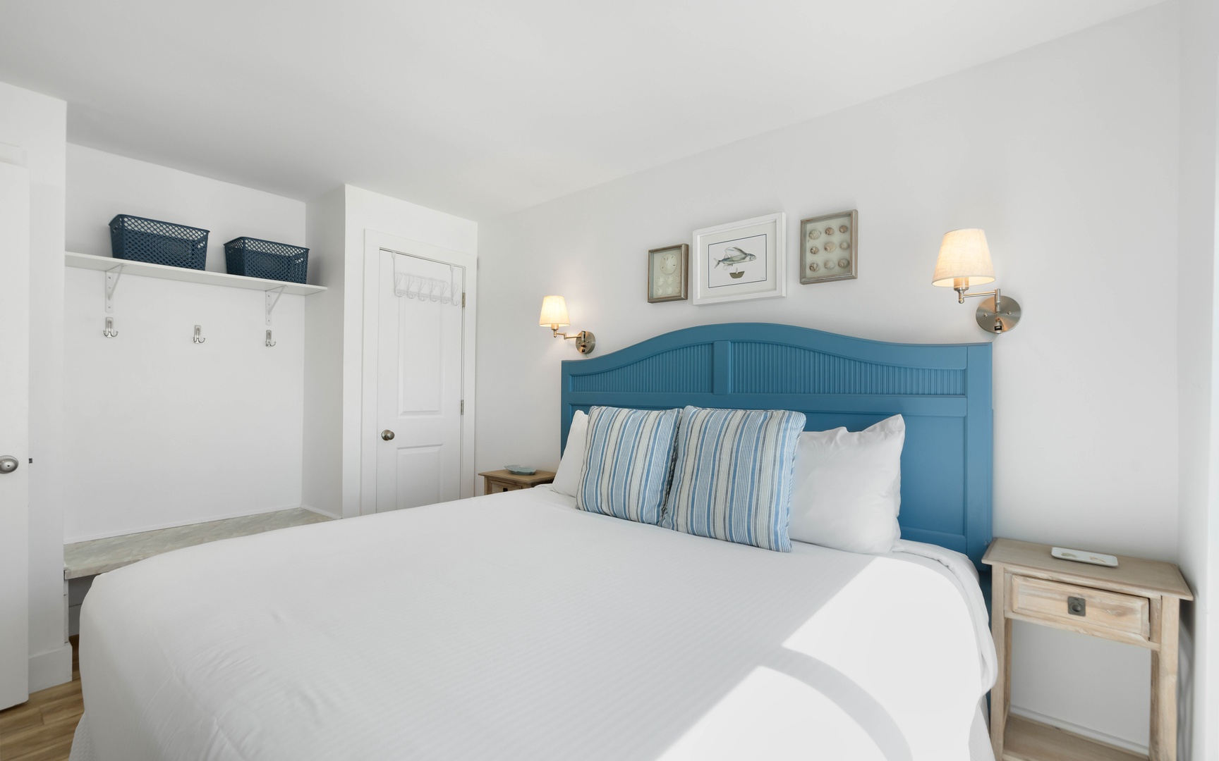 Your cozy bedroom features crisp white linens, coastal blue accents, and warm bedside lighting for peaceful nights.
