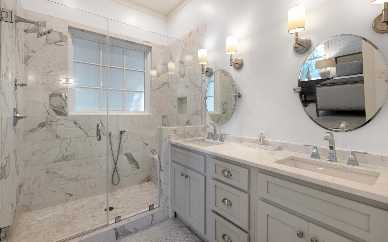 Step into your luxurious marble bathroom with a spacious walk-in shower and elegant dual vanities, perfect for your morning routine.