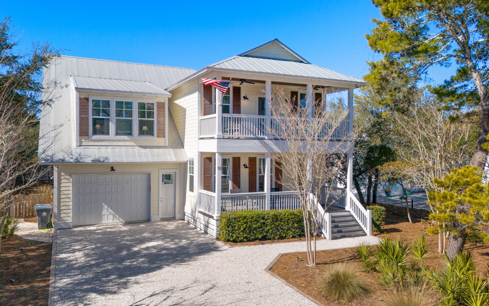 Charming coastal home featuring multiple covered porches, private parking, and peaceful landscaped surroundings for your perfect getaway.