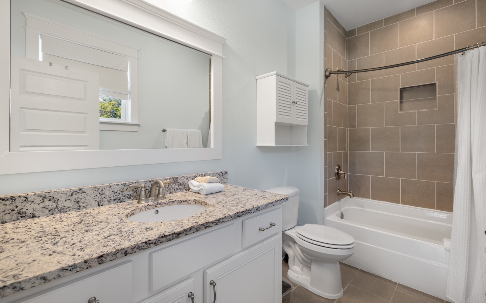 Unwind in your beautifully appointed bathroom featuring granite counters, a soaking tub, and elegant tile work for your comfort.