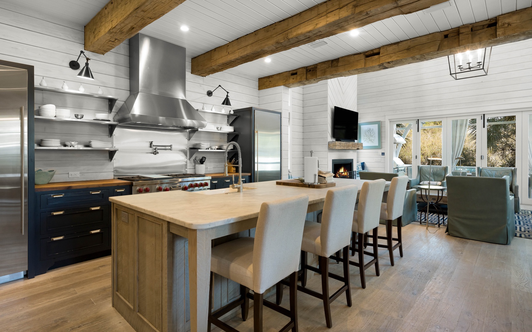 Your spacious kitchen opens to a cozy living area, featuring exposed beams, modern appliances, and a generous island for cooking together.