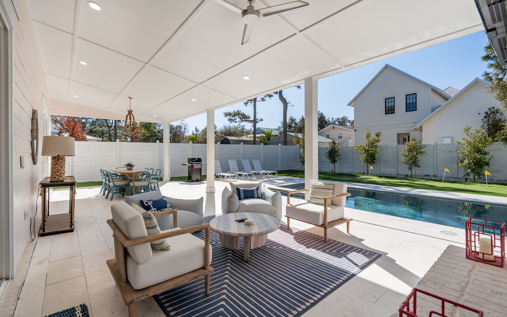 Your covered patio invites relaxation with plush seating and pool views, perfect for morning coffee or evening gatherings.