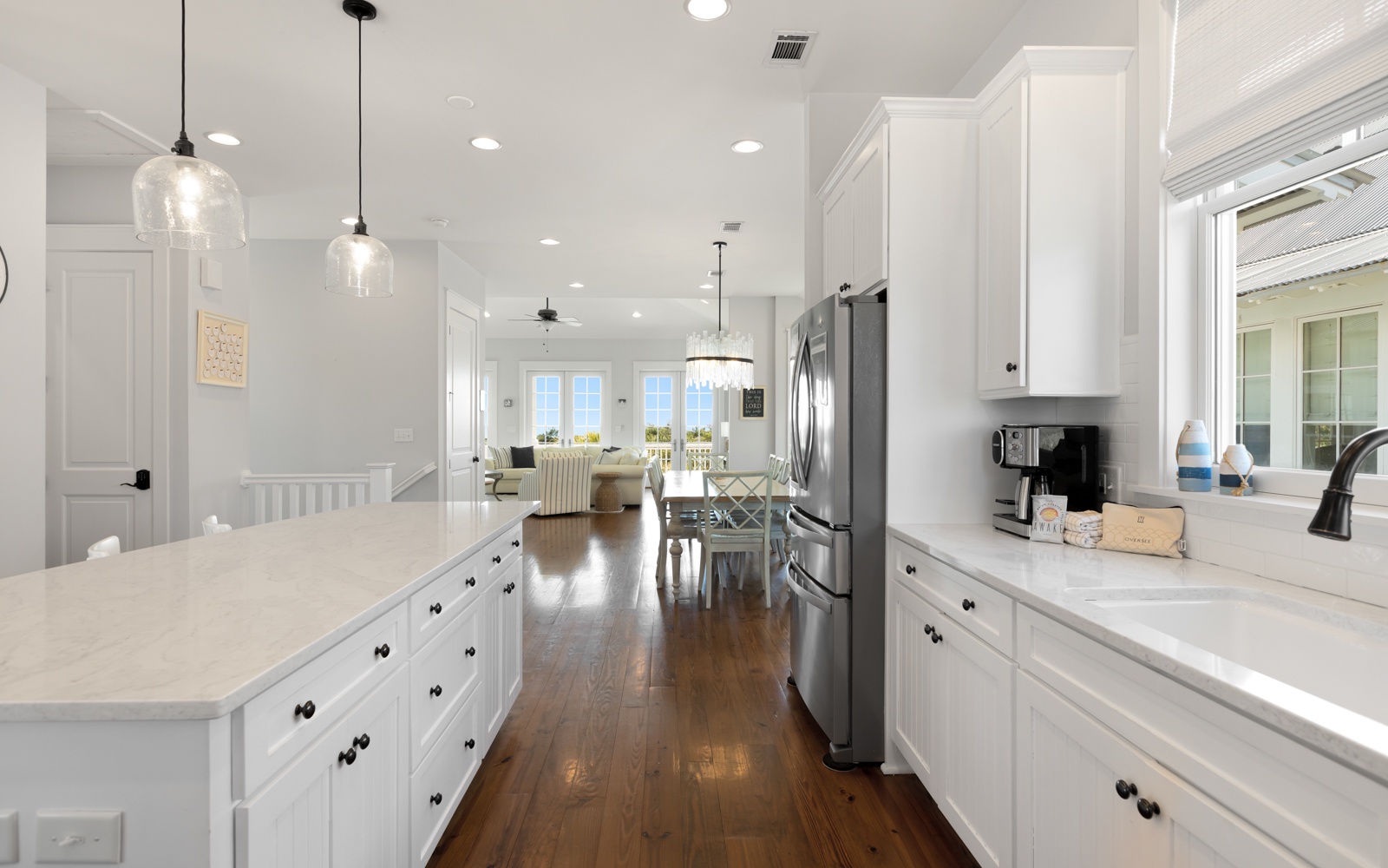 Cook and gather in your bright, airy kitchen featuring gleaming white cabinets, spacious counters, and warm hardwood floors.