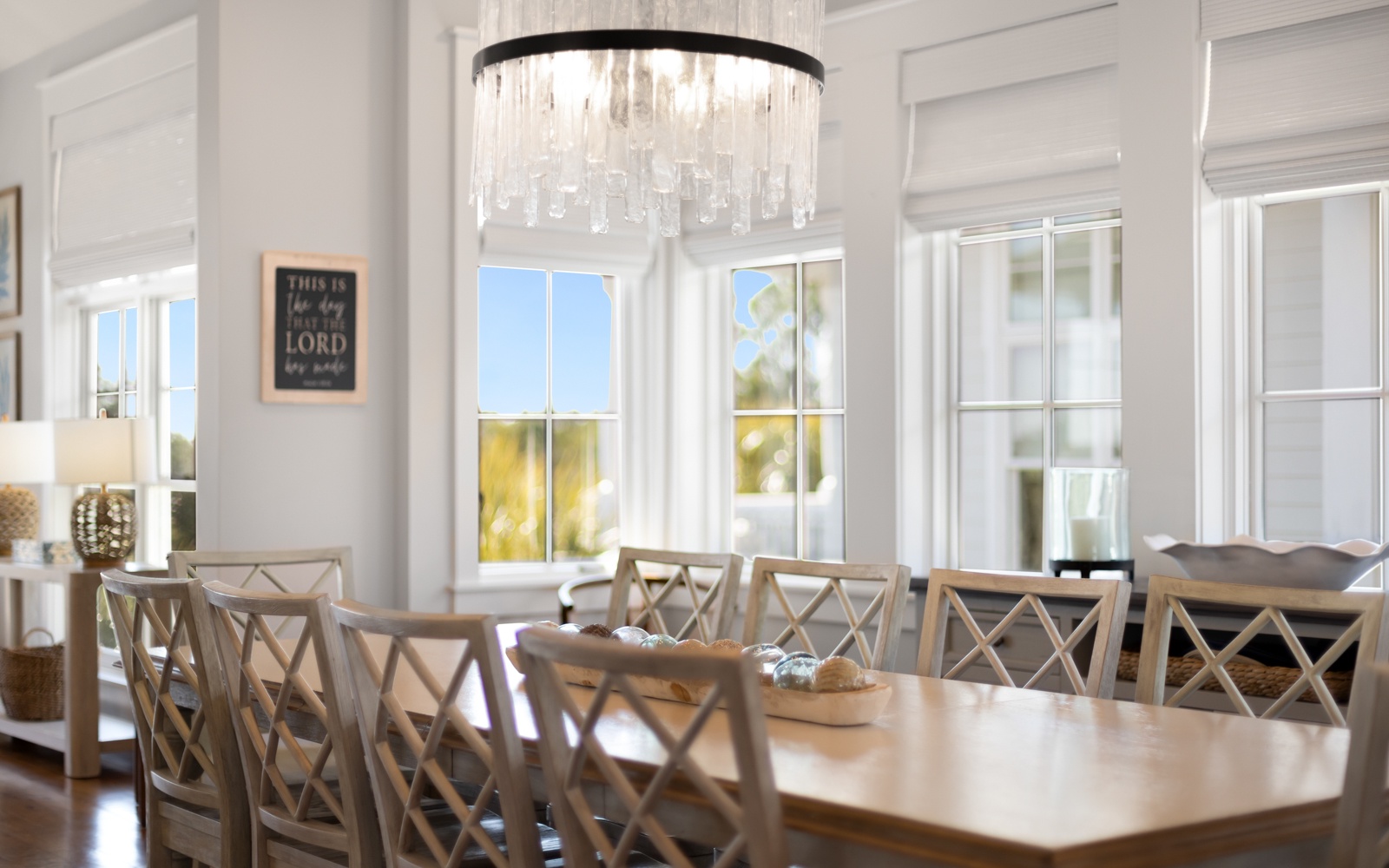 Gather around this elegant dining table where your group can share memorable meals beneath the sparkling chandelier.