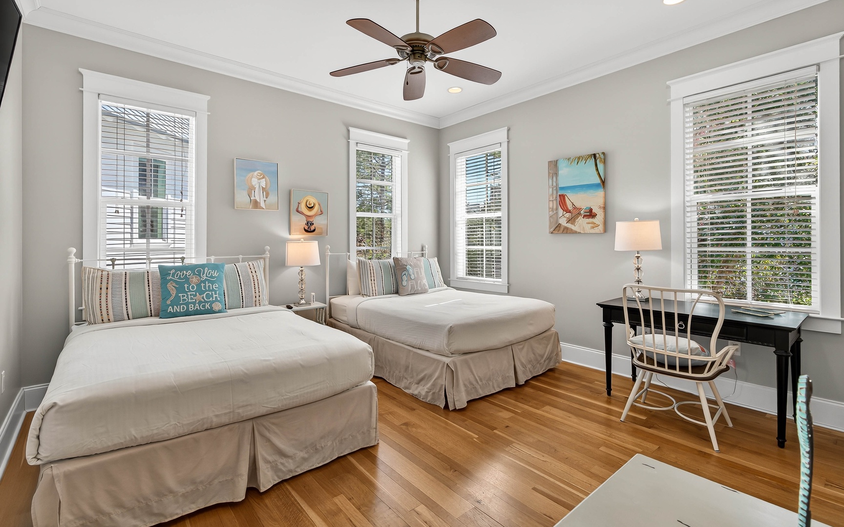 Relax in your bright twin bedroom with coastal touches, where warm wood floors and cheerful decor create the perfect retreat.