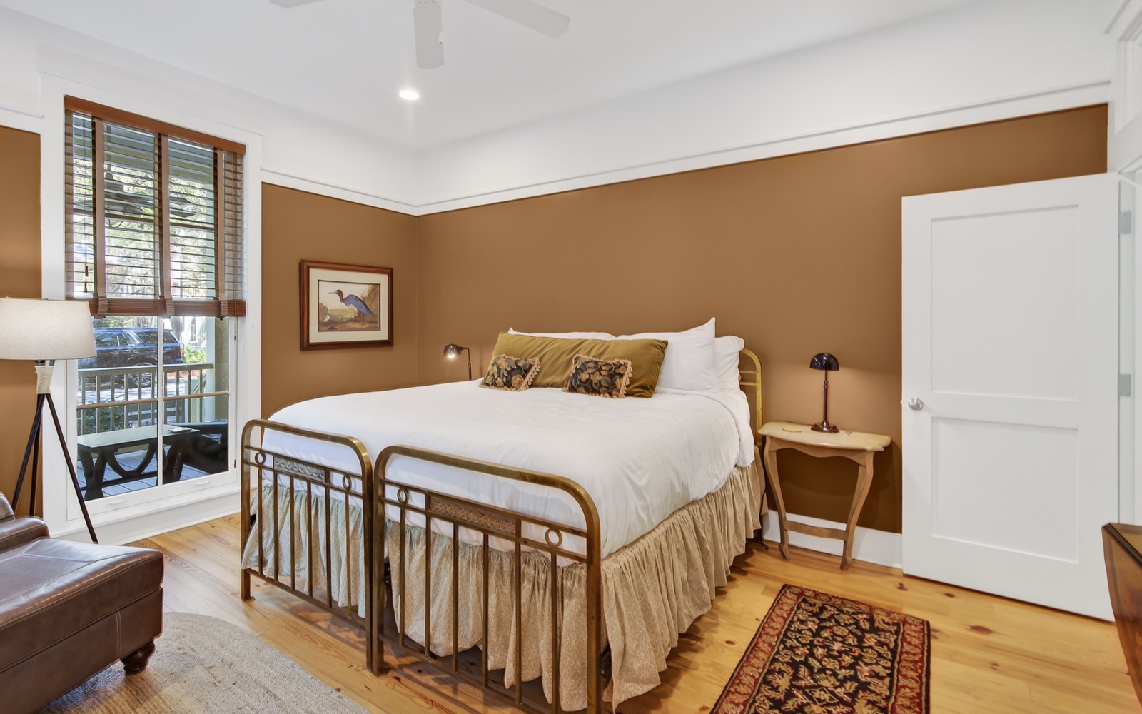Sink into crisp white linens and let warm wood tones embrace you in this charming bedroom retreat.