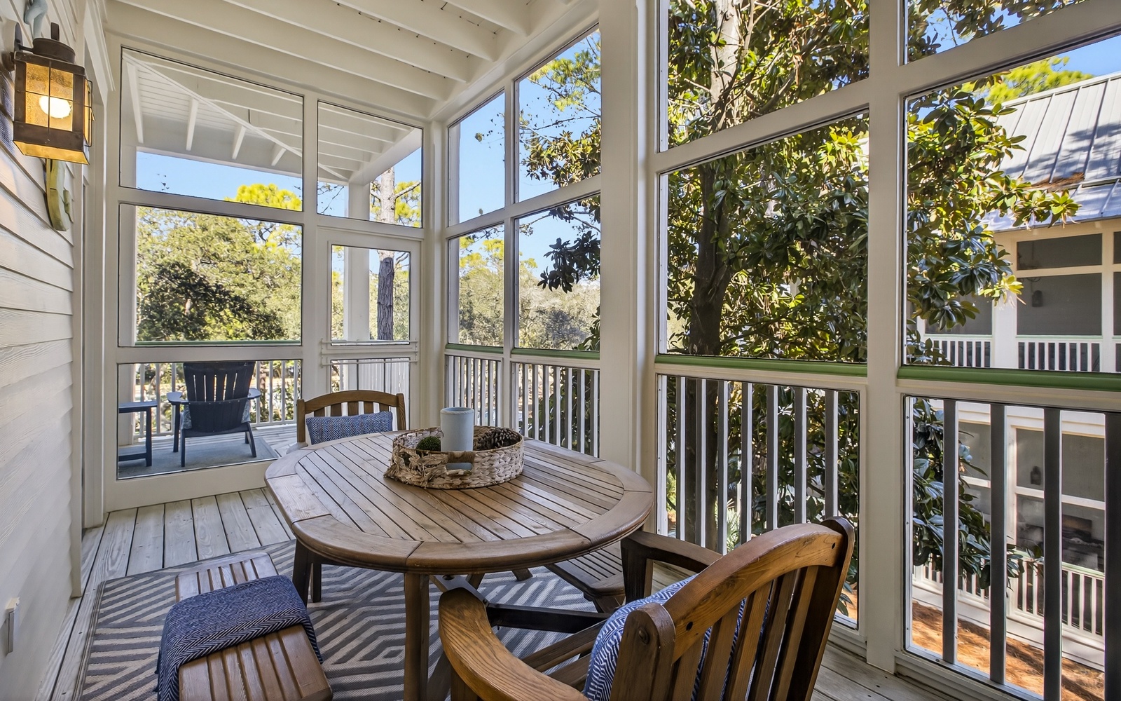 Enjoy morning coffee or afternoon meals in your private screened porch, where sunlight filters through mature trees and gentle breezes flow through.