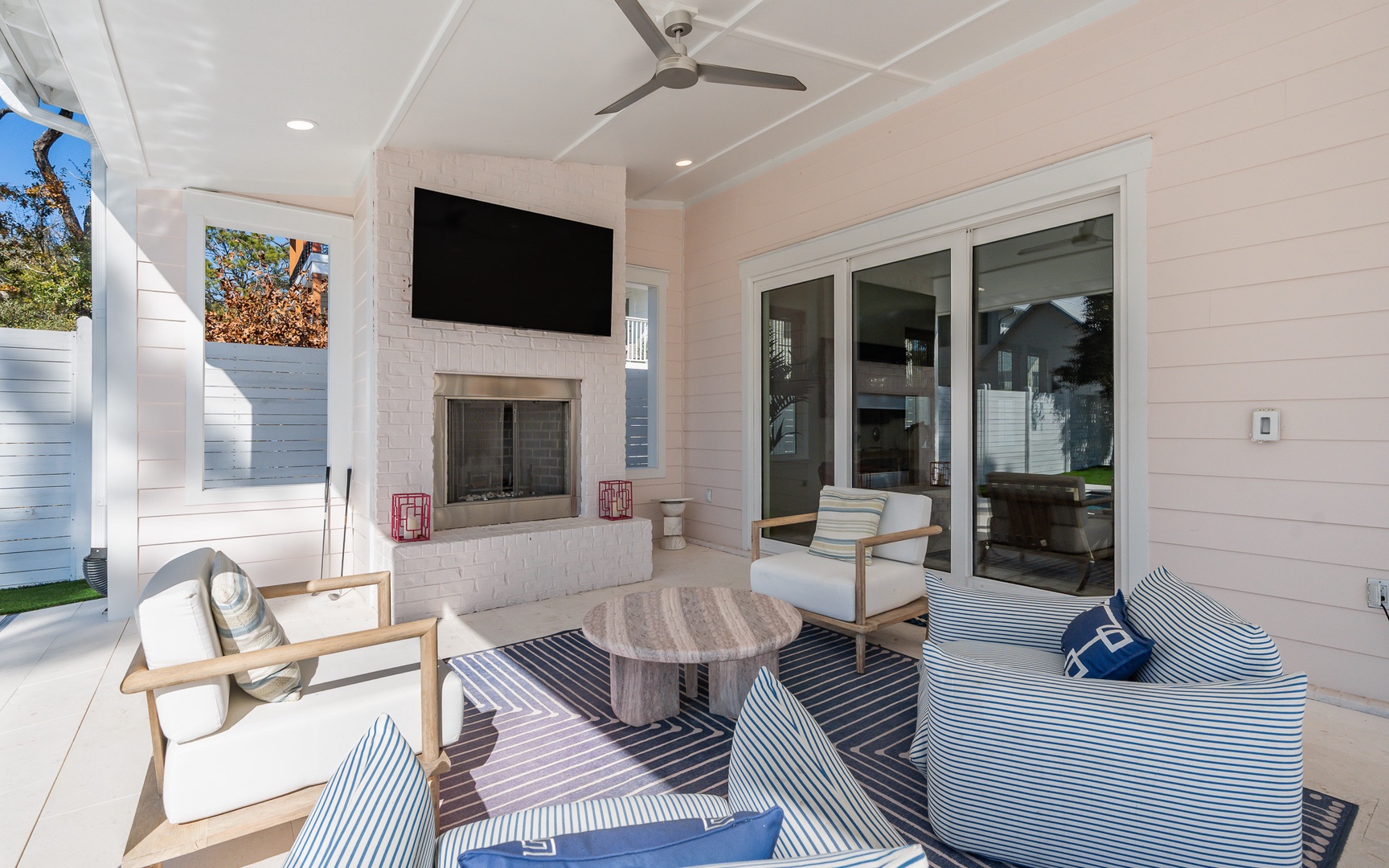 Unwind in your private covered patio with cozy seating, warm fireplace, and flat-screen TV—perfect for relaxing evenings outdoors.