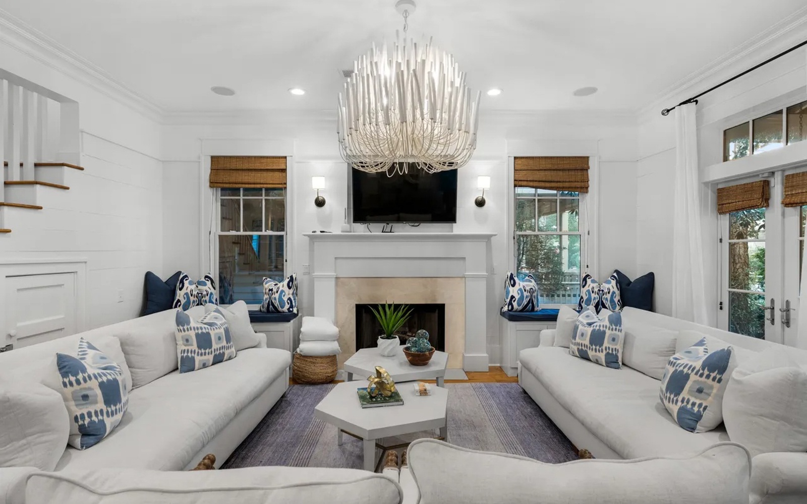 Sink into plush sofas where natural light streams through bamboo blinds, creating your perfect retreat.