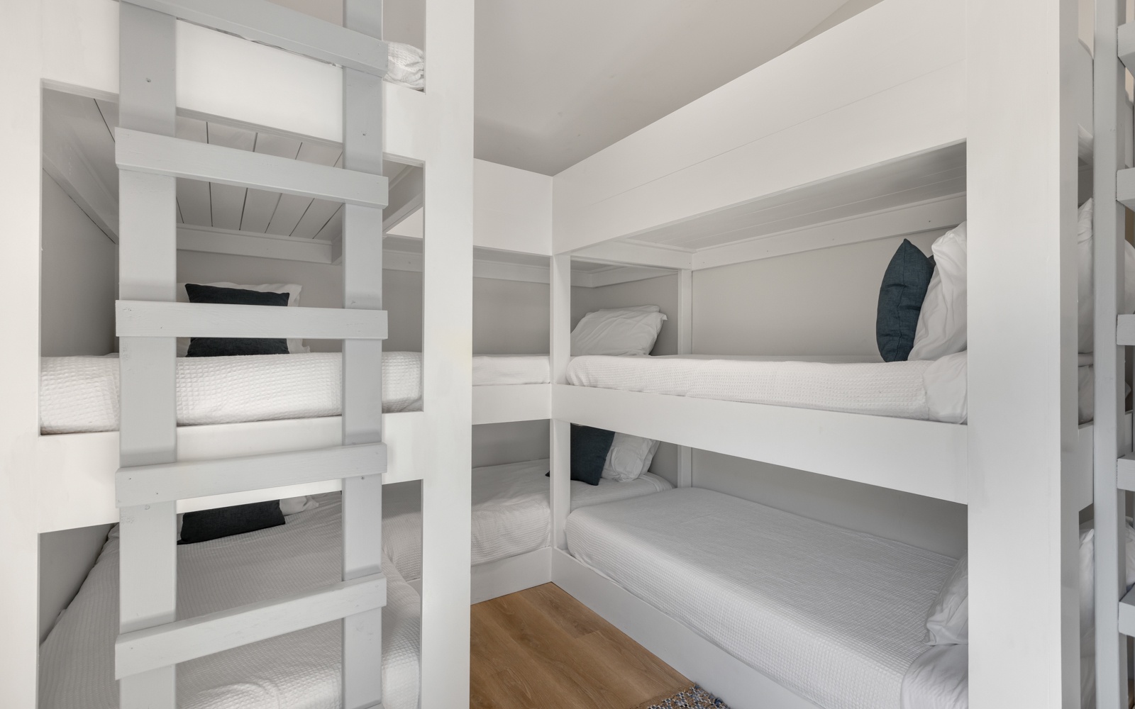 Sleep soundly in your cozy built-in bunk space with crisp white linens and thoughtful design details for comfort.