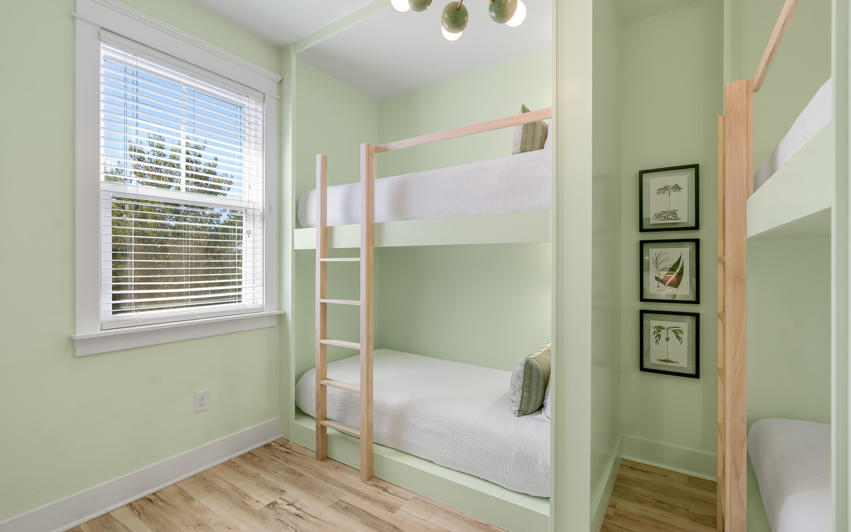Your cozy bunk room features built-in beds with soft green walls, creating a peaceful retreat for restful nights.