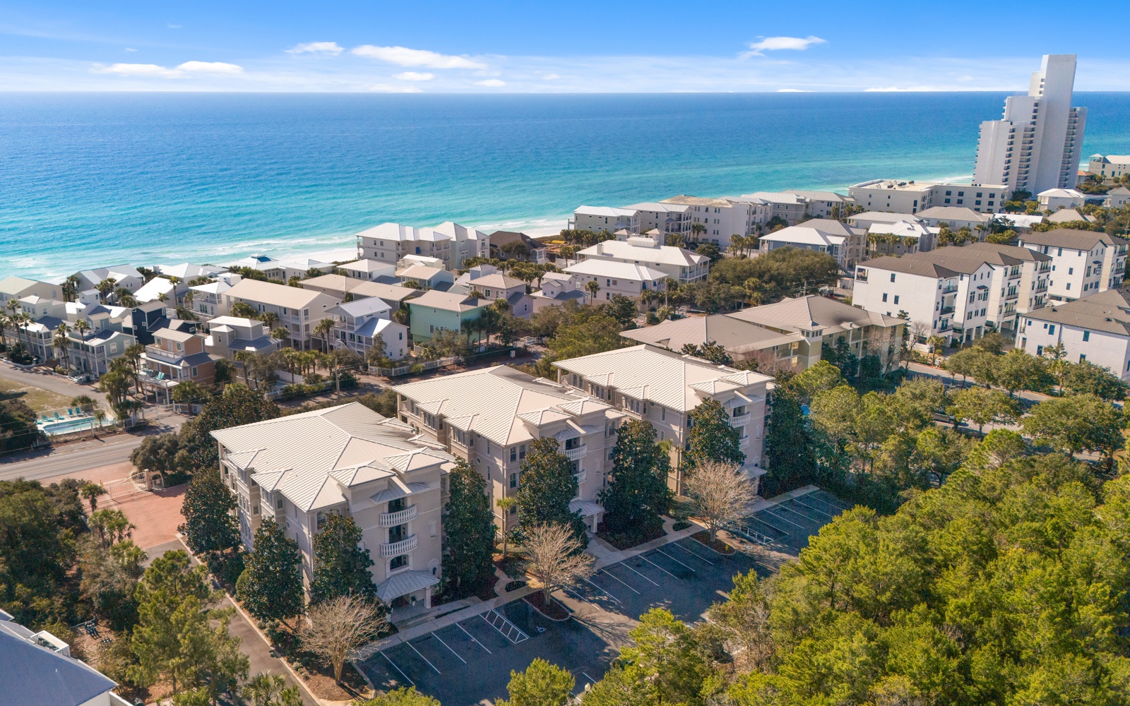 Beachfront community nestled between emerald waters and lush greenery, offering direct beach access and coastal living.