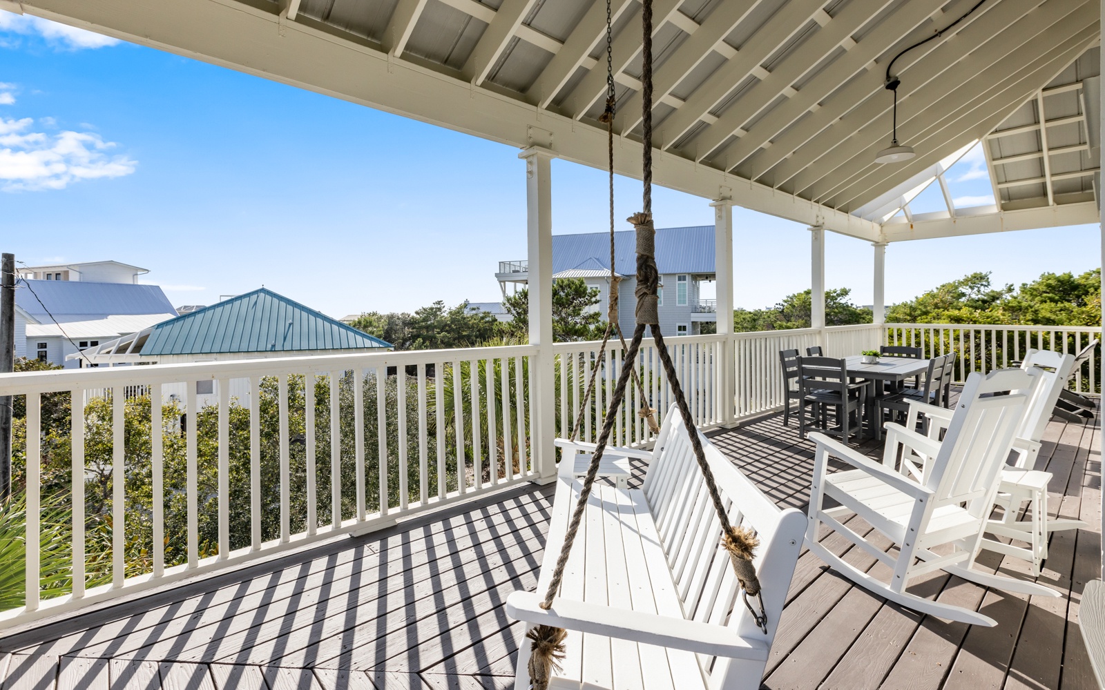 Sway on your private porch swing while taking in coastal views from this charming covered deck with dining space.