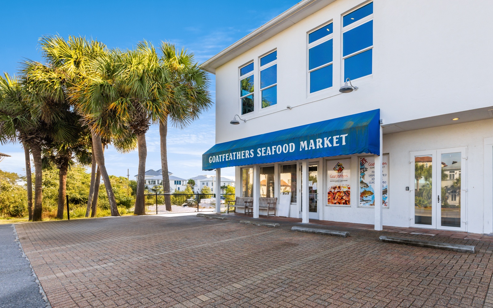 Fresh seafood market located within walking distance, surrounded by tropical palm trees and coastal charm.