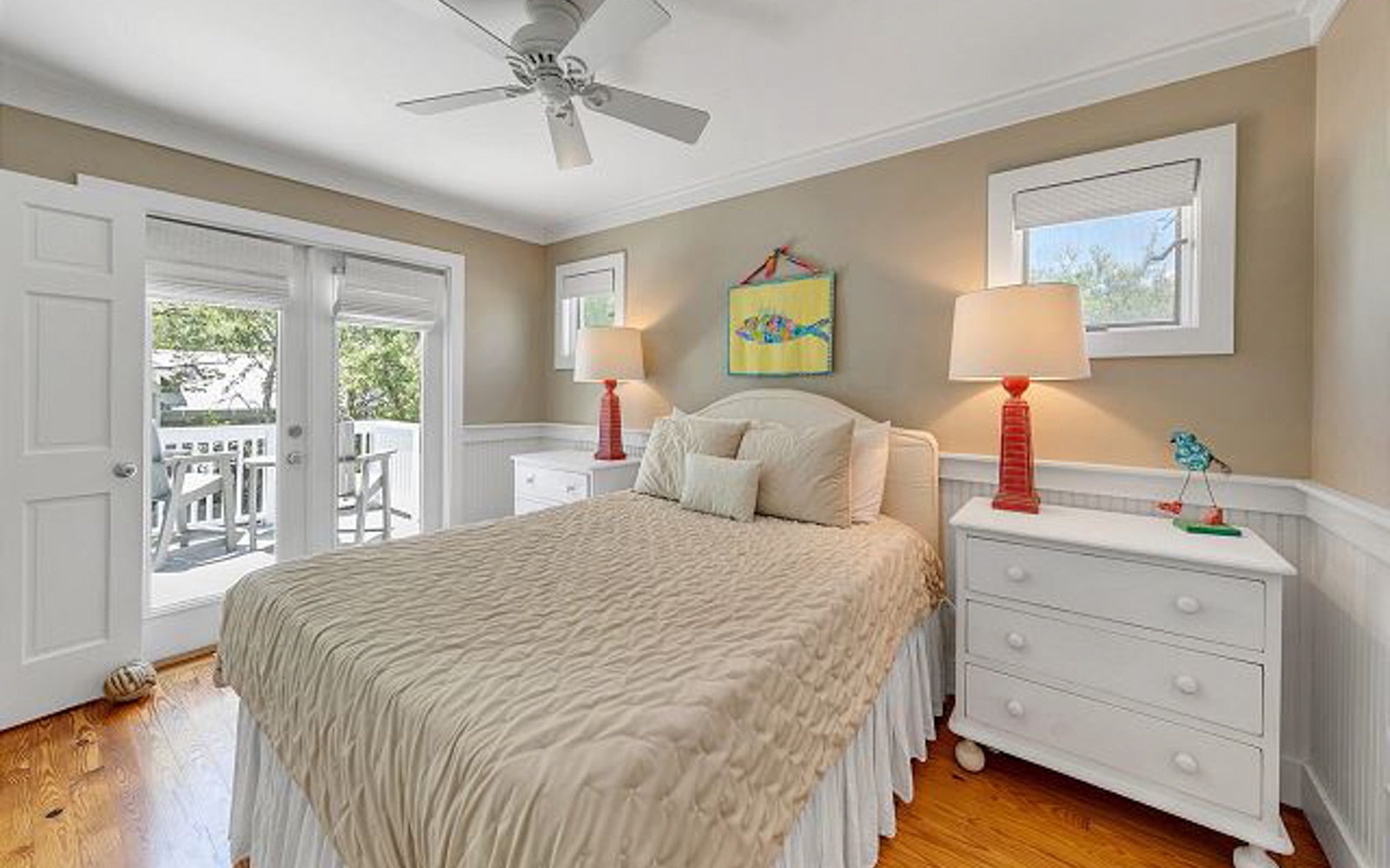 Wake up in this cozy bedroom where warm colors and gentle breezes from your private balcony create the perfect peaceful retreat.