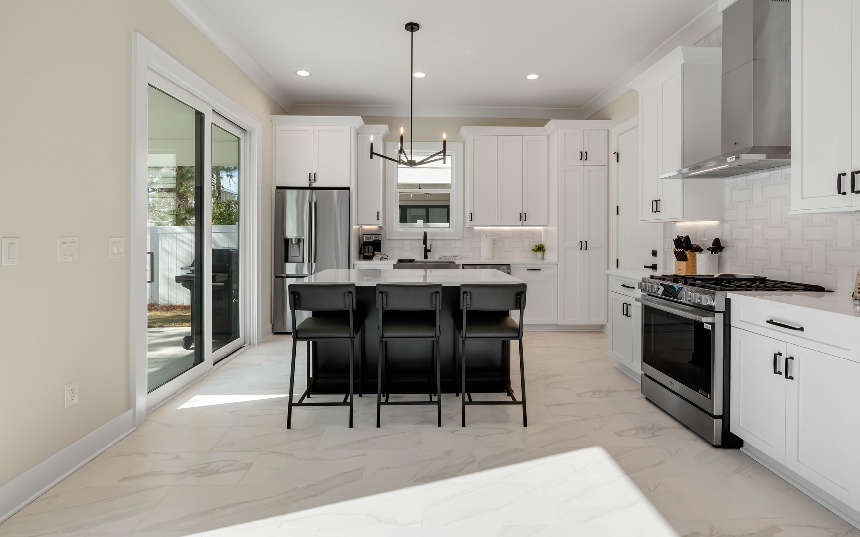 Your spacious kitchen features gleaming white cabinets, granite counters, and premium stainless appliances perfect for preparing memorable meals together.