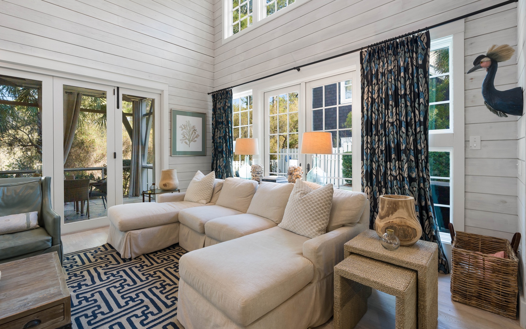 Sink into the plush sectional and let coastal charm embrace you in this sun-drenched living room, where French doors open to your private terrace retreat.