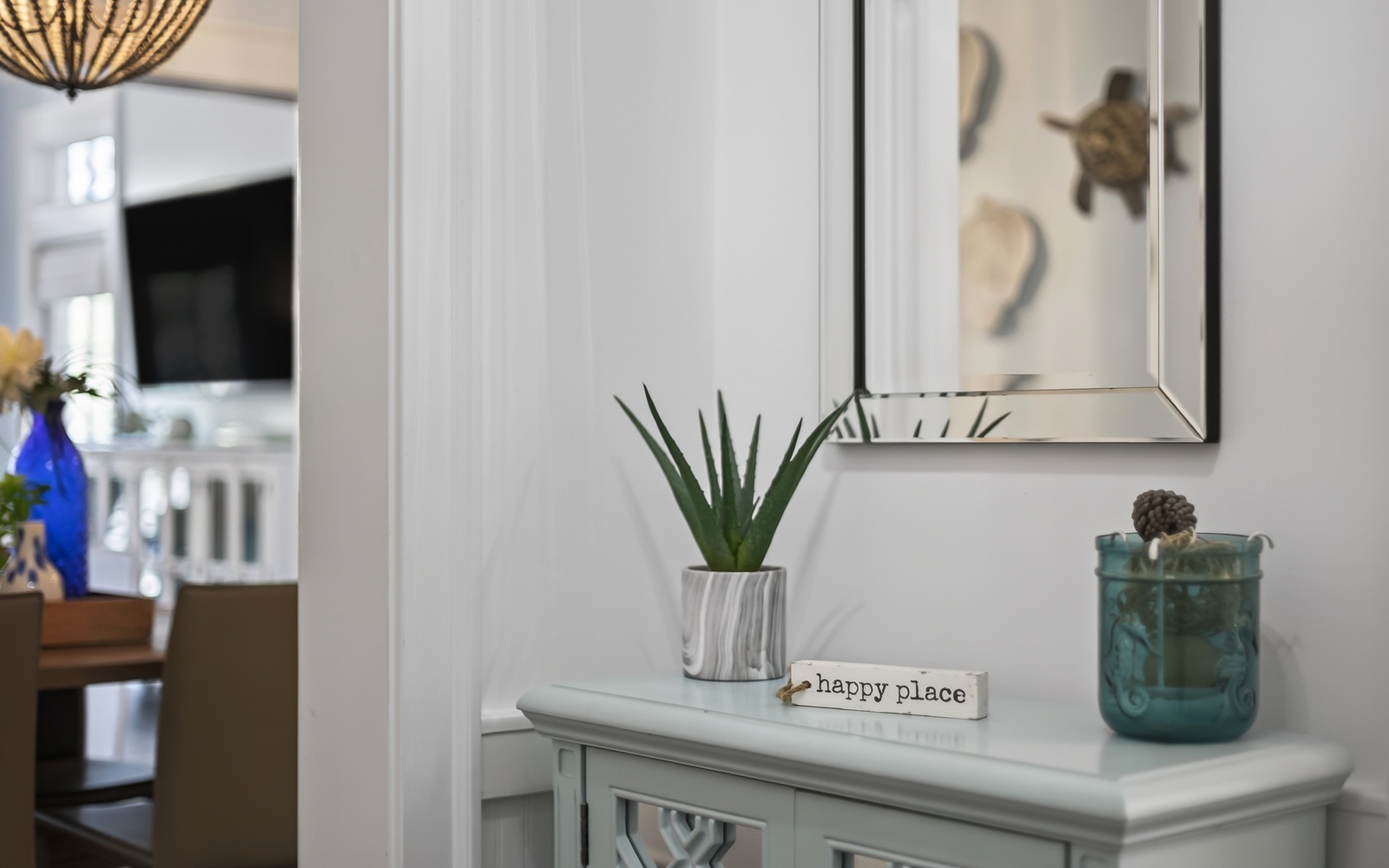 Thoughtful touches like this "happy place" sign and coastal decor create your welcoming retreat from the moment you arrive.