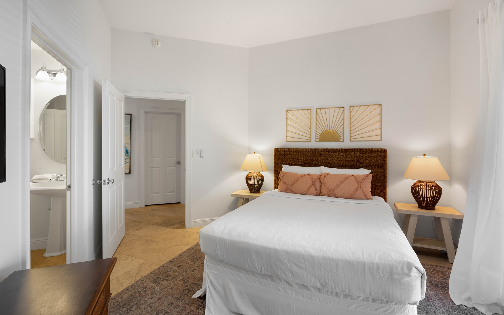 Sink into crisp linens and soft pillows in your serene bedroom, where warm lighting and thoughtful touches create the perfect retreat.