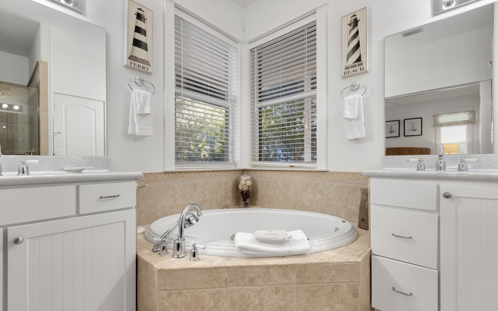 Luxurious master bath with soaking tub where you can unwind after your day, bathed in natural light from windows.