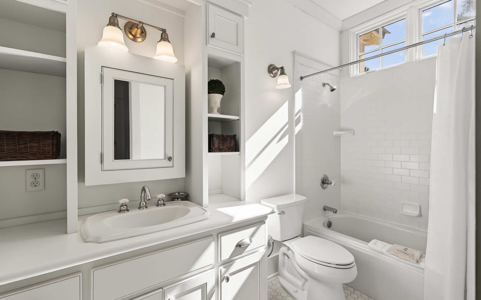 Step into your serene bathroom sanctuary, where crisp white subway tiles and warm natural light create a spa-like retreat for your morning rituals.