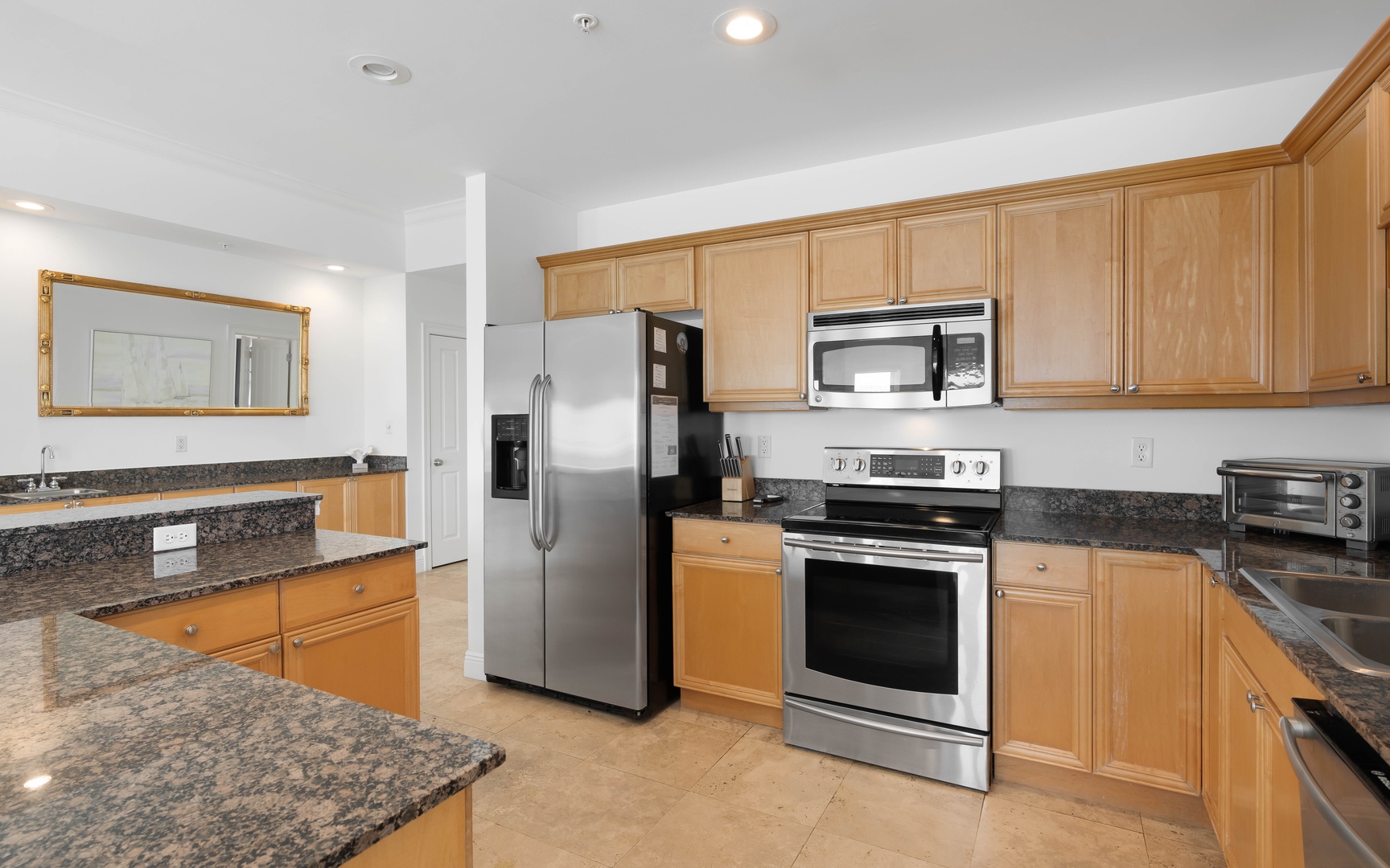 Your spacious kitchen awaits with granite countertops, stainless steel appliances, and warm maple cabinets for all your culinary adventures.
