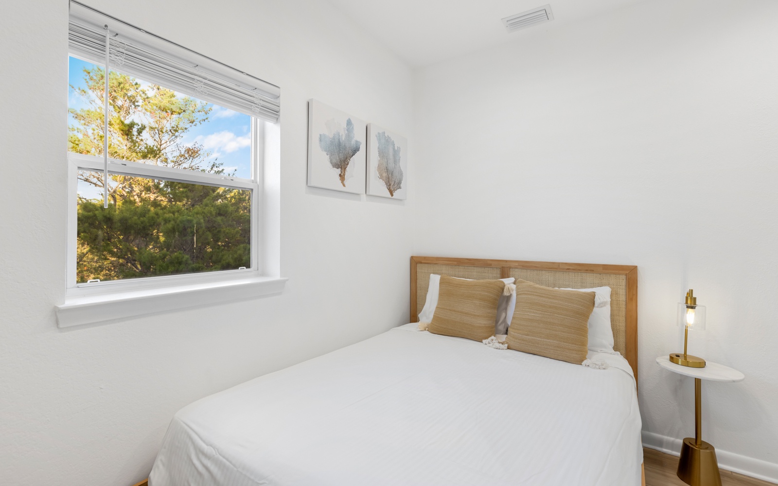 Wake up in your peaceful bedroom with crisp white linens and natural light streaming through the window.