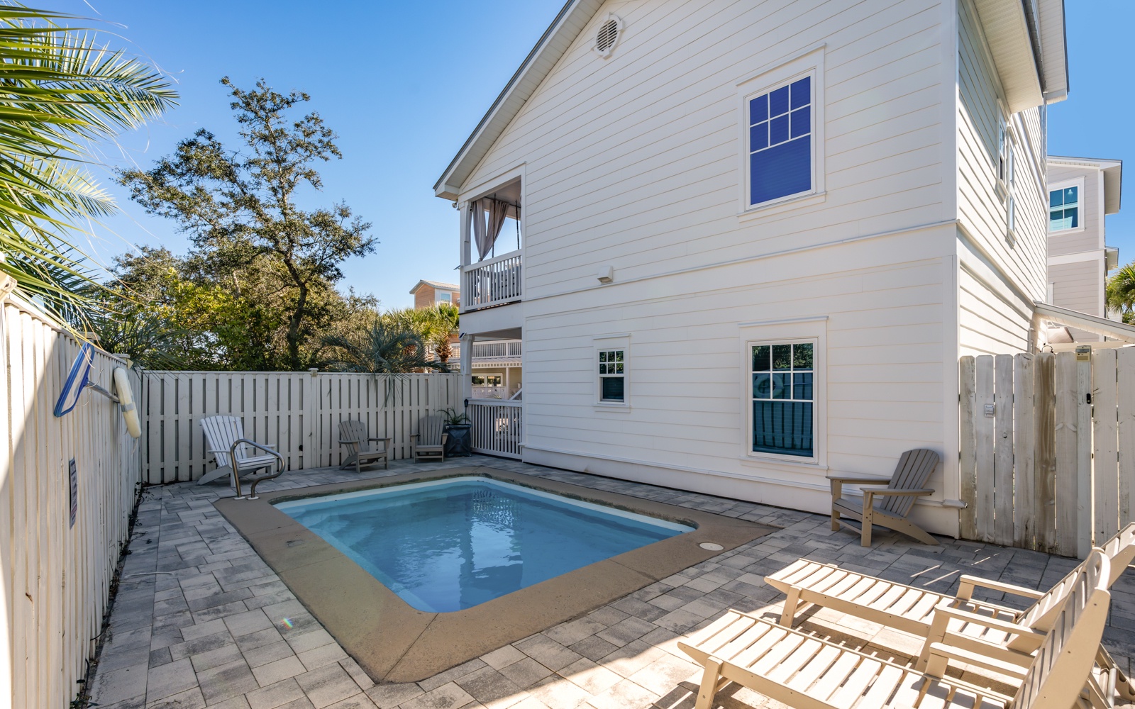 Your private backyard oasis awaits with sparkling pool and sunny lounging deck for perfect poolside relaxation.