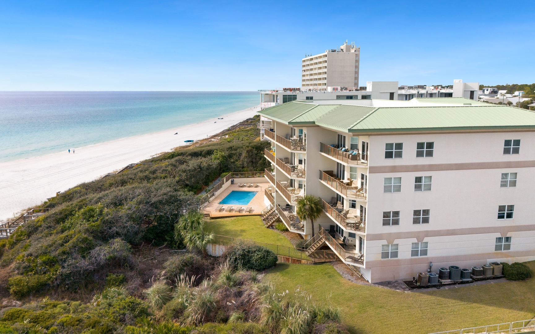 Beachfront property featuring pristine white sand beach access, swimming pool, and stunning coastal location.