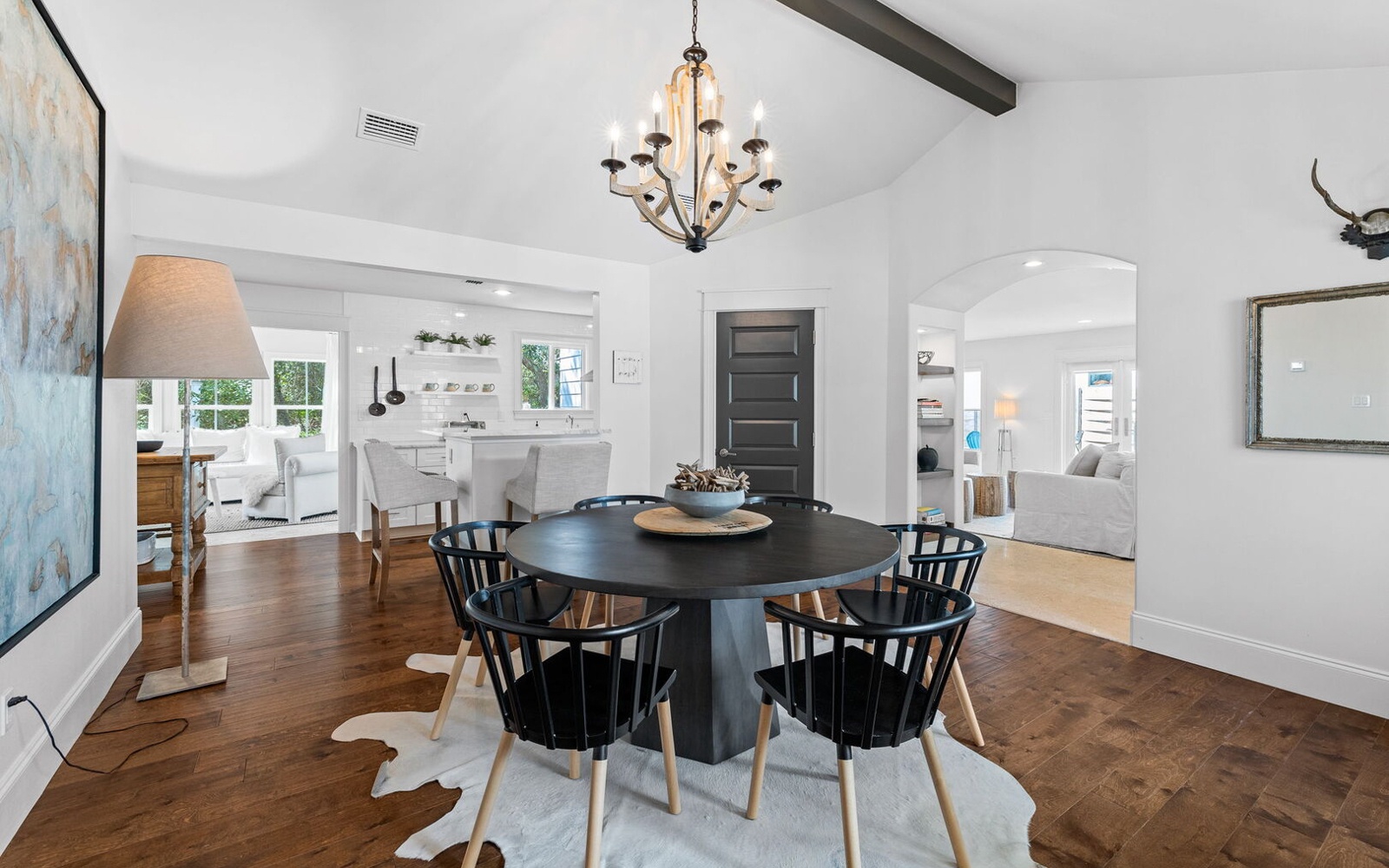 Gather around this elegant round table for memorable meals with your group, illuminated by a stunning chandelier in this open-concept space.