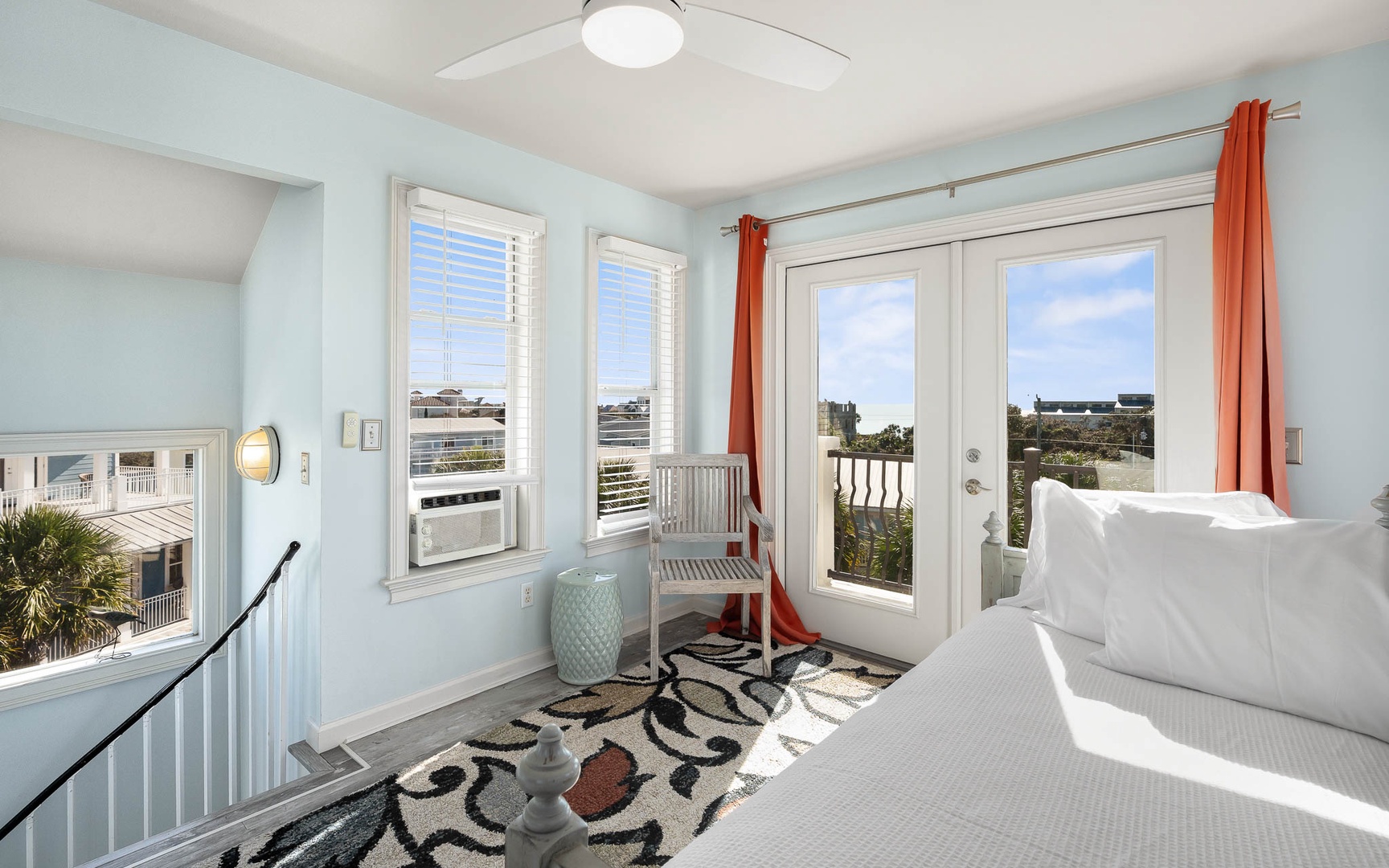 Wake up to stunning views from your bright bedroom with French doors opening to a private balcony overlooking the coastal landscape.