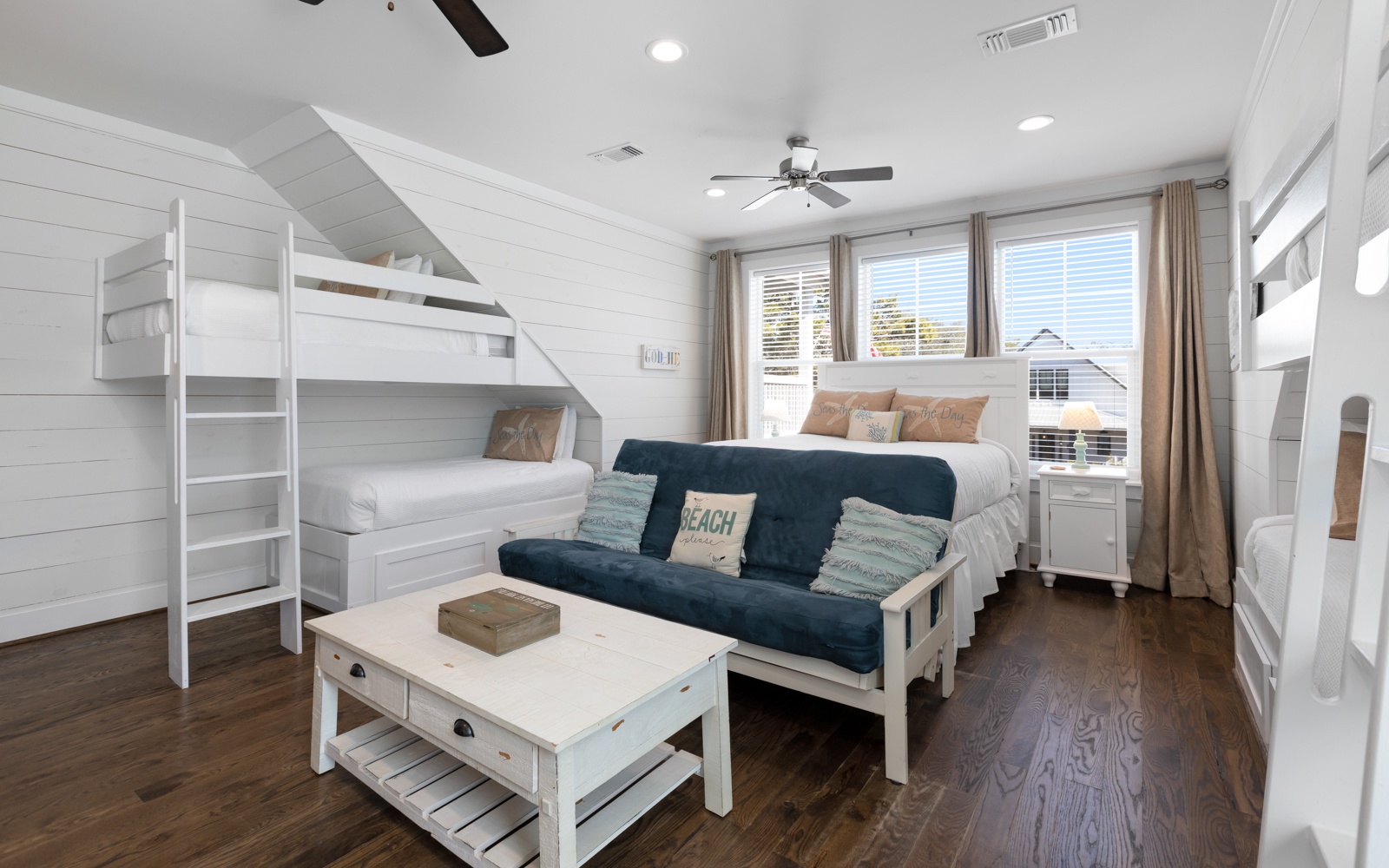 Your coastal-themed room offers flexible sleeping with bunk beds, a queen bed, and pull-out futon—perfect for families or groups seeking comfort and space.