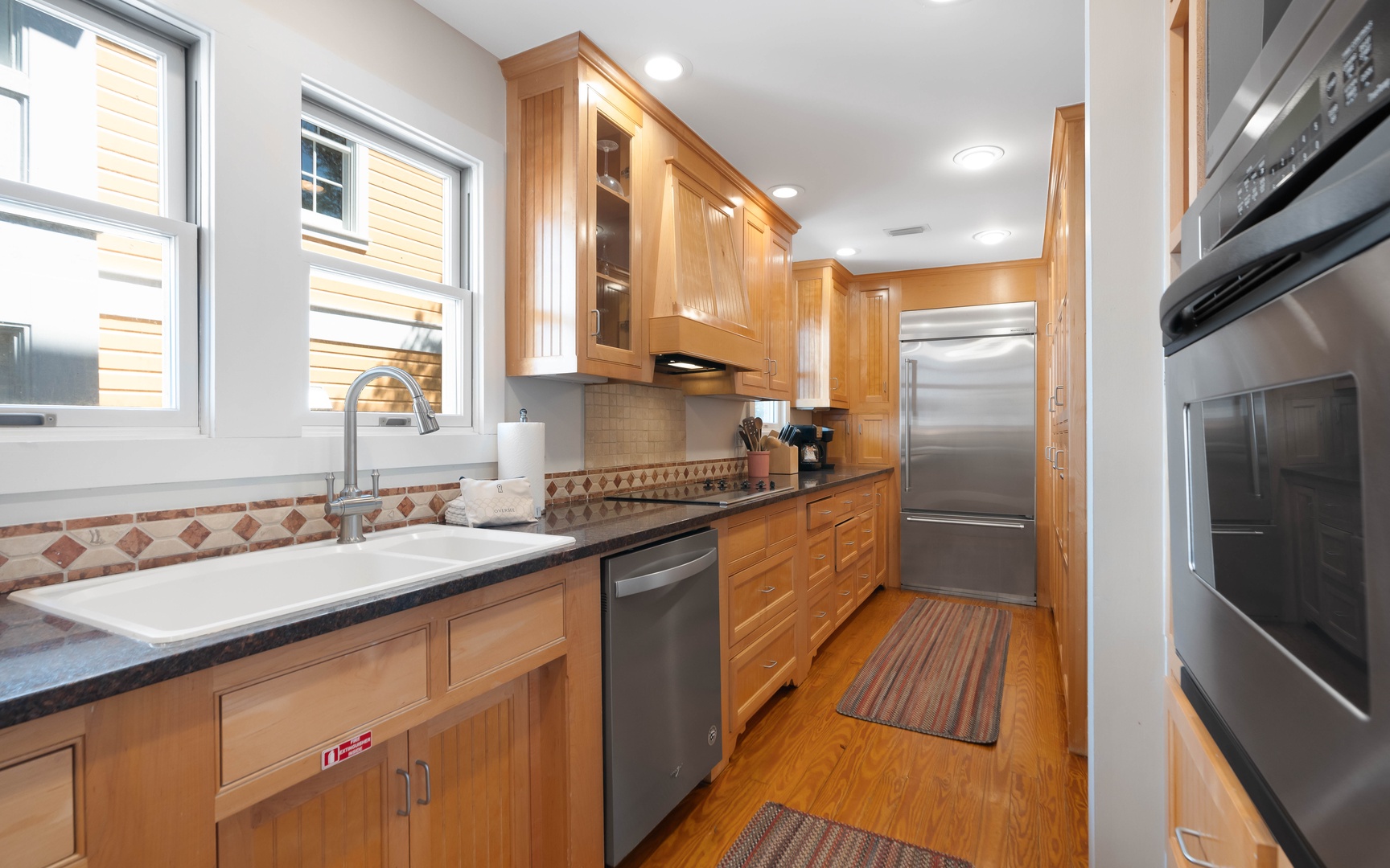 Your fully equipped kitchen features beautiful wood cabinetry, modern stainless appliances, and everything you need to create memorable meals together.
