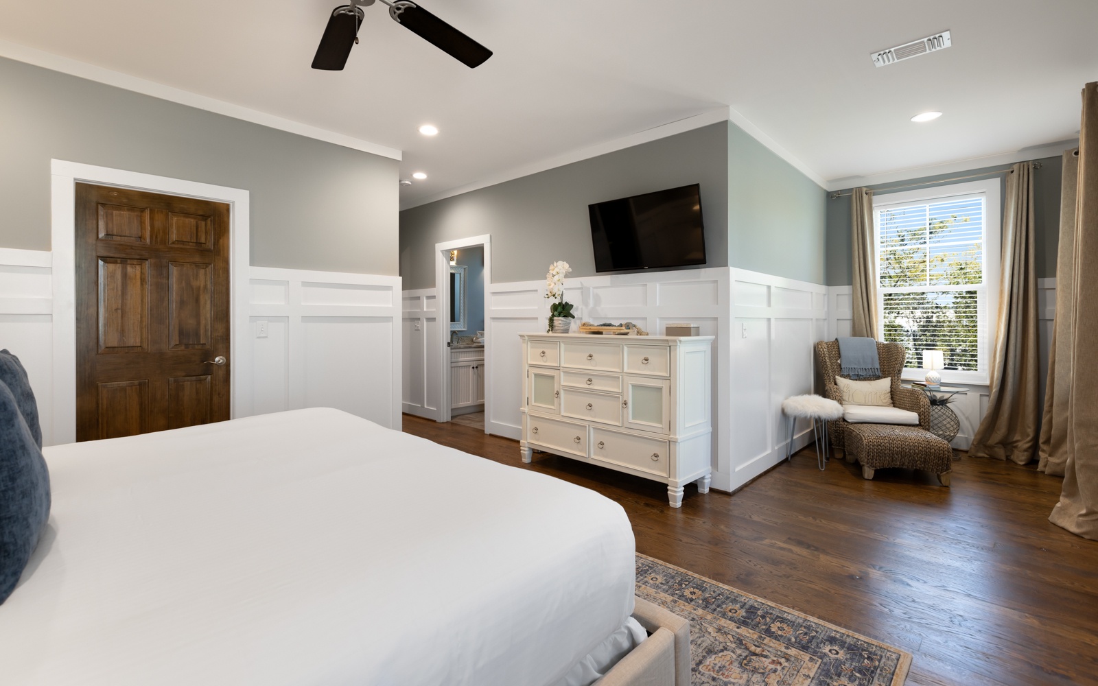You'll love unwinding in this spacious master bedroom featuring cozy seating, smart storage, and elegant details for your perfect retreat.
