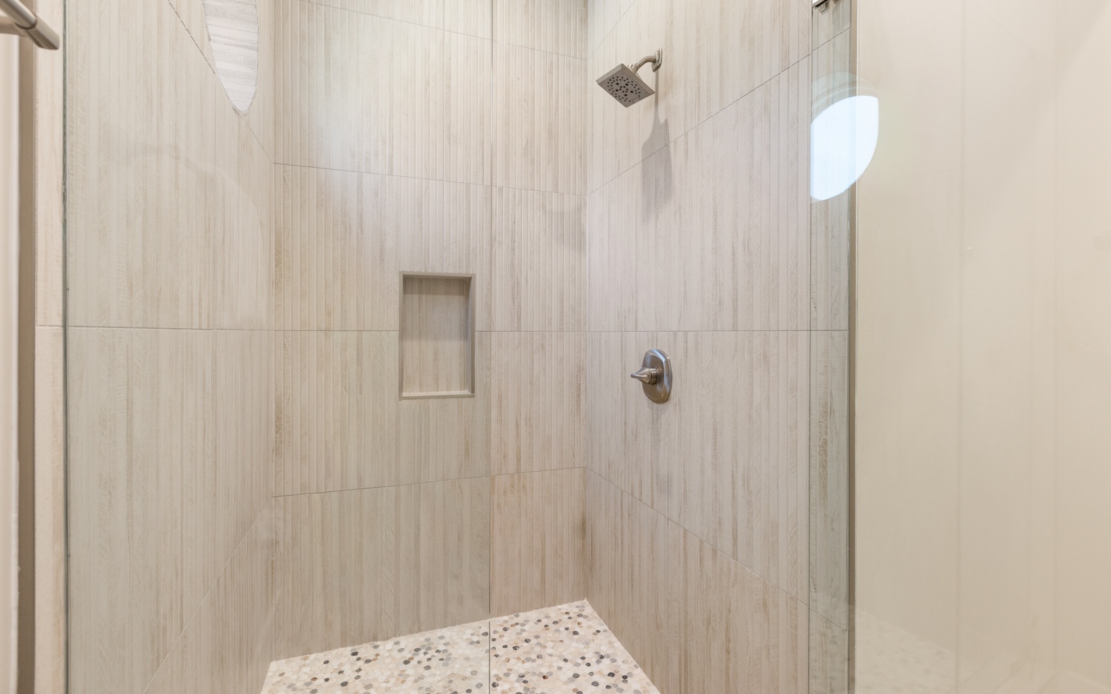 Step into your private oasis with elegant tiled walls and a refreshing rainfall shower to wash away the day.
