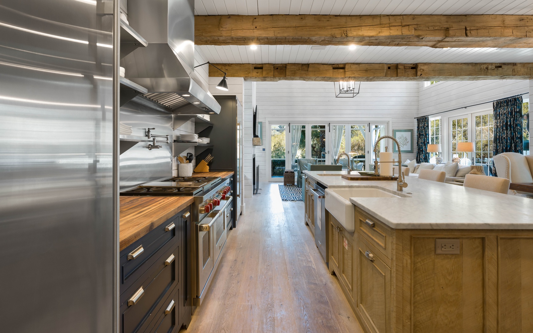 You'll love cooking in this spacious chef's kitchen with exposed beams, professional appliances, and a large island perfect for gathering.